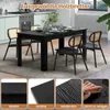 A black dining table with four chairs in a modern kitchen setting. Náhled obrázku produktu