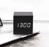 A black digital alarm clock with a white display showing the time is placed on a laptop. Produktbild-Vorschau