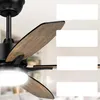 A close-up view of a black ceiling fan with wooden blades, with white rectangular overlays on the right side. Podgląd zdjęcia produktu