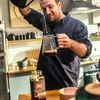 A man is making coffee in a kitchen. Produktbild-Vorschau