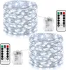 Two spools of white LED string lights with battery packs and remote controls. Produktbild-Vorschau