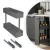 A collage showing a kitchen cabinet pull-out organizer with two shelves and its components, alongside a view of the organizer installed in a kitchen cabinet filled with bottles. Produktbild-Vorschau