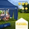 A family is sitting under a blue pop-up tent in a grassy outdoor setting. Anteprima dell’immagine prodotto