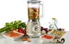 A vintage-style blender is shown on a white surface with various ingredients and prepared dishes around it. Anteprima dell’immagine prodotto
