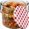 A close-up shot of a glass jar filled with mixed vegetables and sealed with a red and white checkered lid. Anteprima dell’immagine prodotto