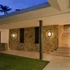 Outdoor walkway and stairs of a modern house at dusk, illuminated by wall lights. Produktbild-Vorschau