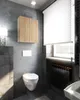 A modern bathroom with a wall-mounted cabinet, toilet, and radiator. Voir les images du produit