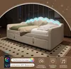 A beige upholstered sofa bed with LED lighting on the headboard, set up in a room with a patterned rug. Náhled obrázku produktu