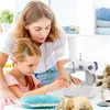A woman is teaching a young girl how to use a sewing machine. Produktbild-Vorschau