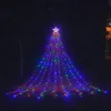 A star-shaped waterfall light decoration resembling a Christmas tree, illuminated with colorful LED lights, set up outdoors at night. Produktbild-Vorschau