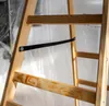Close-up view of a wooden ladder with a black strap. Produktbild-Vorschau