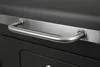 A close-up shot of a handle on a black grill. Produktbild-Vorschau