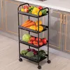 A black metal kitchen cart filled with various fruits and vegetables, placed in a kitchen setting. Produktbild-Vorschau