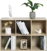 A six-compartment cube shelf unit made of light oak wood-effect material, decorated with various items including books, a statue, a plant, and a framed picture. Produktbild-Vorschau