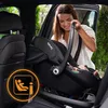 A woman is placing a baby car seat into a car. Náhled obrázku produktu