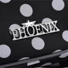 Close-up of a black fabric with white polka dots, featuring a silver Phoenix logo. Produktbild-Vorschau