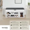 A shoe bench with storage and a cushioned top, displayed in a home setting with shoes inside. Produktbild-Vorschau