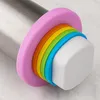 Close-up of the end of a stainless steel rolling pin with colorful silicone rings. Produktbild-Vorschau