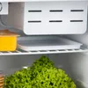 Inside view of a refrigerator shelf with food items. Voir les images du produit