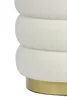 A close-up view of the bottom section of a white, textured pouf with a gold base. Produktbild-Vorschau
