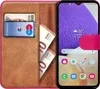 A book-style phone case with a smartphone inside, showing cards and banknotes in the case's slots. Produktbild-Vorschau