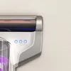 A close-up view of a white and silver vacuum cleaner with blue indicator lights and a brush roll. Náhled obrázku produktu
