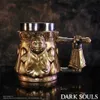 A golden mug with a sculpted face and handle, set against a dark, smoky background. Podgląd zdjęcia produktu