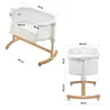 Two views of a white baby bassinet with wooden rocking legs, with dimensions labeled. Produktbild-Vorschau