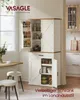 A VASAGLE kitchen cabinet in a farmhouse style, filled with various kitchen items, is shown in a bright, airy room with a window and a dining table with stools. Produktbild-Vorschau