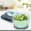A salad spinner with chopped lettuce inside rests on a countertop. Anteprima dell’immagine prodotto