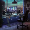 A gaming desk setup in a room with a city view at night. Produktbild-Vorschau