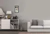 A multi-photo frame is displayed on a wall above a white cabinet, next to a sofa. Náhľad obrázku produktu