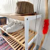 A shoe rack with shoes, a hat, and a bow and arrow. Podgląd zdjęcia produktu