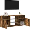 A TV cabinet with open doors and shelves, displaying decorative items and books. Produktbild-Vorschau