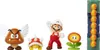 A collection of Super Mario figurines and a building block accessory, arranged on a white background. Produktbild-Vorschau