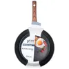 A black frying pan with a wooden handle, presented on a white background with packaging. Produktbild-Vorschau