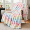 A soft, colorful blanket draped over a chair in a room with a window. Produktbild-Vorschau