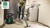 A person is using a wet/dry vacuum cleaner to clean up a spill on the floor in a laundry room. Voir les images du produit