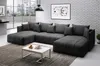 A modern living room with a large sectional sofa, a coffee table, and artwork on the wall. Produktbild-Vorschau
