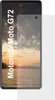 A screen protector is shown partially covering a smartphone displaying a sunset over water. Podgląd zdjęcia produktu