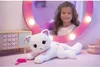A plush cat toy is placed on a vanity table in front of a mirror reflecting a young girl. Anteprima dell’immagine prodotto