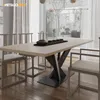 A dining table with a metal base and chairs in a modern dining room setting. Voir les images du produit