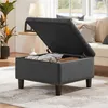 A storage ottoman is open and filled with items, placed in a living room setting. Produktbild-Vorschau