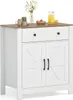 A white kitchen cabinet with a brown countertop and two doors, a drawer, and decorative elements on top. Podgląd zdjęcia produktu