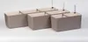 Four self-watering planters are arranged in a row on a white background. Náhled obrázku produktu