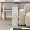 A modern living room setting with a marble-effect side table next to a sofa and chairs. Produktbild-Vorschau