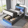 A modern bedroom with a grey upholstered bed frame, featuring LED lighting and open storage compartments. The bed is made up with grey and white bedding. Náhľad obrázku produktu