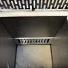 Close-up view inside a grill or smoker, showing a metal grate. Náhľad obrázku produktu