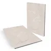 Two vinyl flooring tiles with a stone pattern are shown against a white background. One tile is standing upright, and the other is lying flat in the foreground. Produktbild-Vorschau