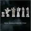 A collection of detailed chess pieces displayed against a dark, smoky background. Podgląd zdjęcia produktu